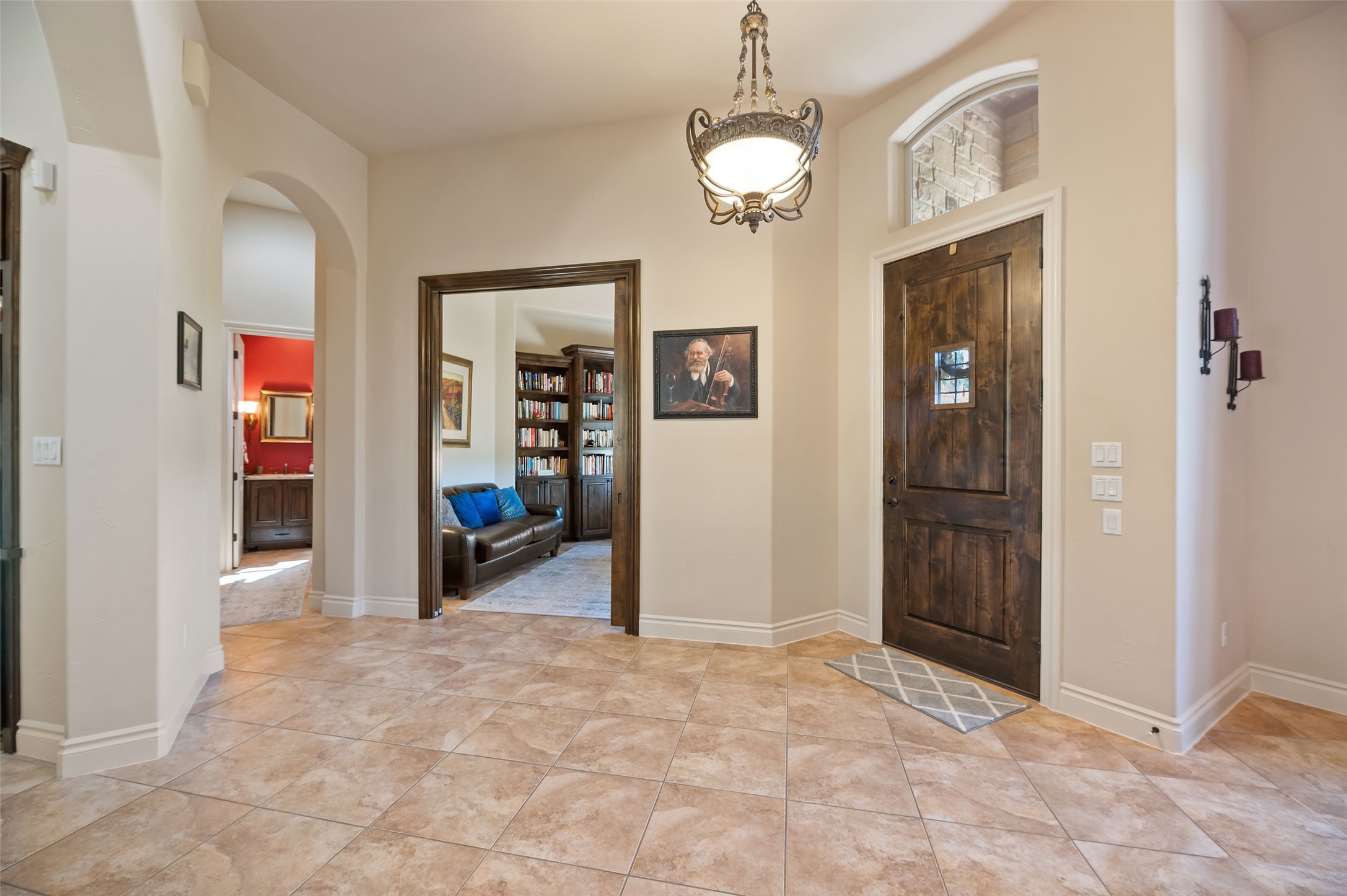 109 Ranchers Club Lane Driftwood, TX 78619 - Photo 3 of 19 Entrance foyer with arched walkways and light tile patterned floors