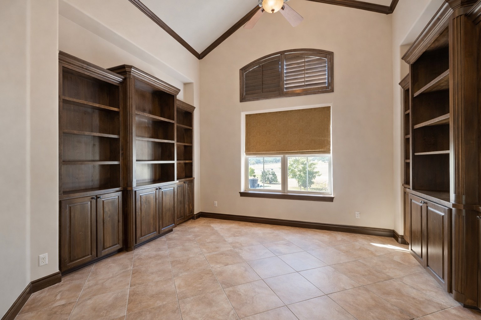 109 Ranchers Club Lane Driftwood, TX 78619 - Photo 4 of 19 Study featuring high vaulted ceiling, light tile patterned flooring, ceiling fan, built in shelves, and ornamental molding