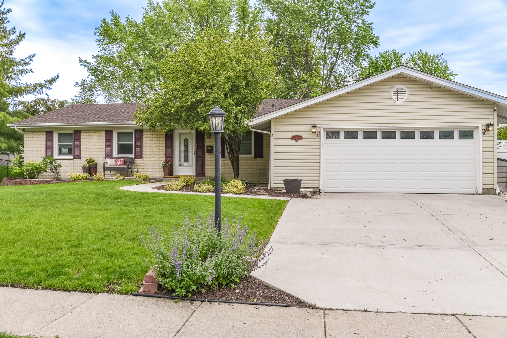 a front view of house with yard and green space