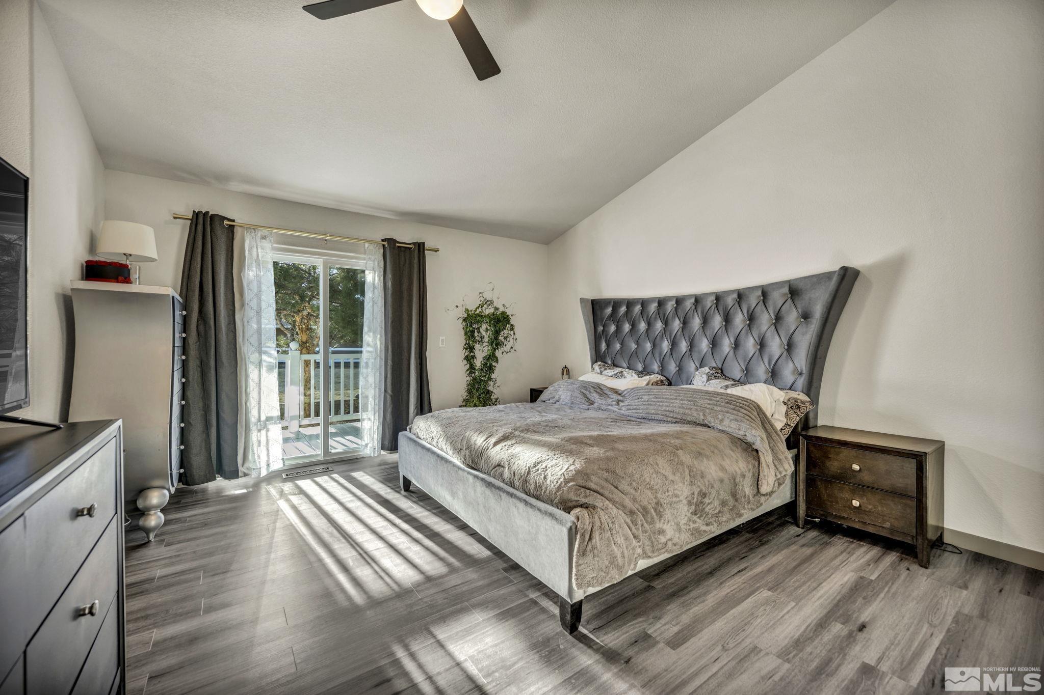 9811 Dixon Lane Reno, NV 89511 - Photo 14 of 40 a bedroom with a bed and wooden floor