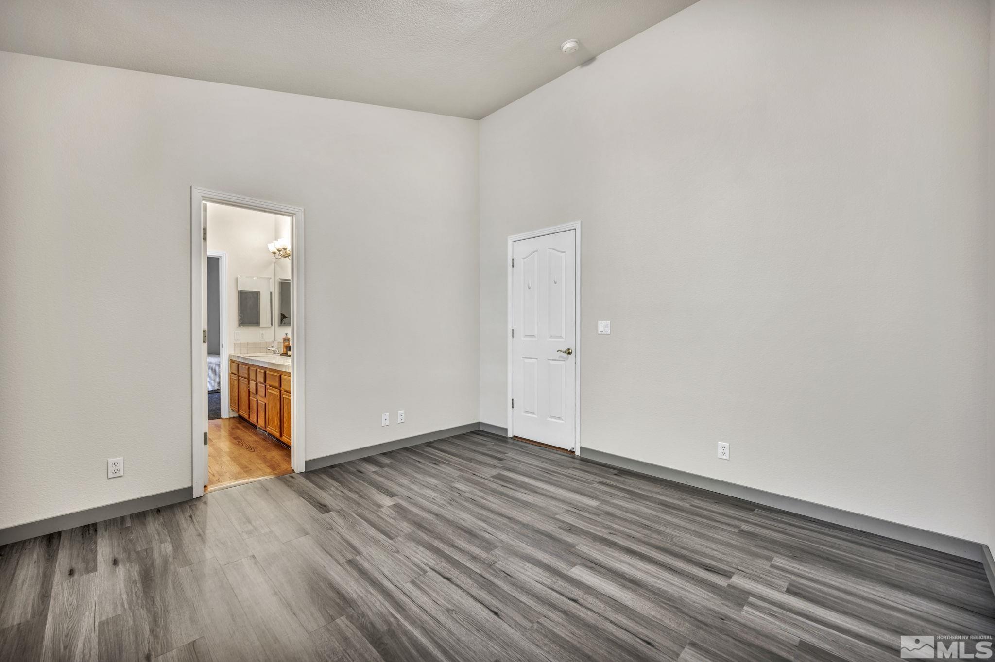 9811 Dixon Lane Reno, NV 89511 - Photo 20 of 40 a view of an empty room with wooden floor