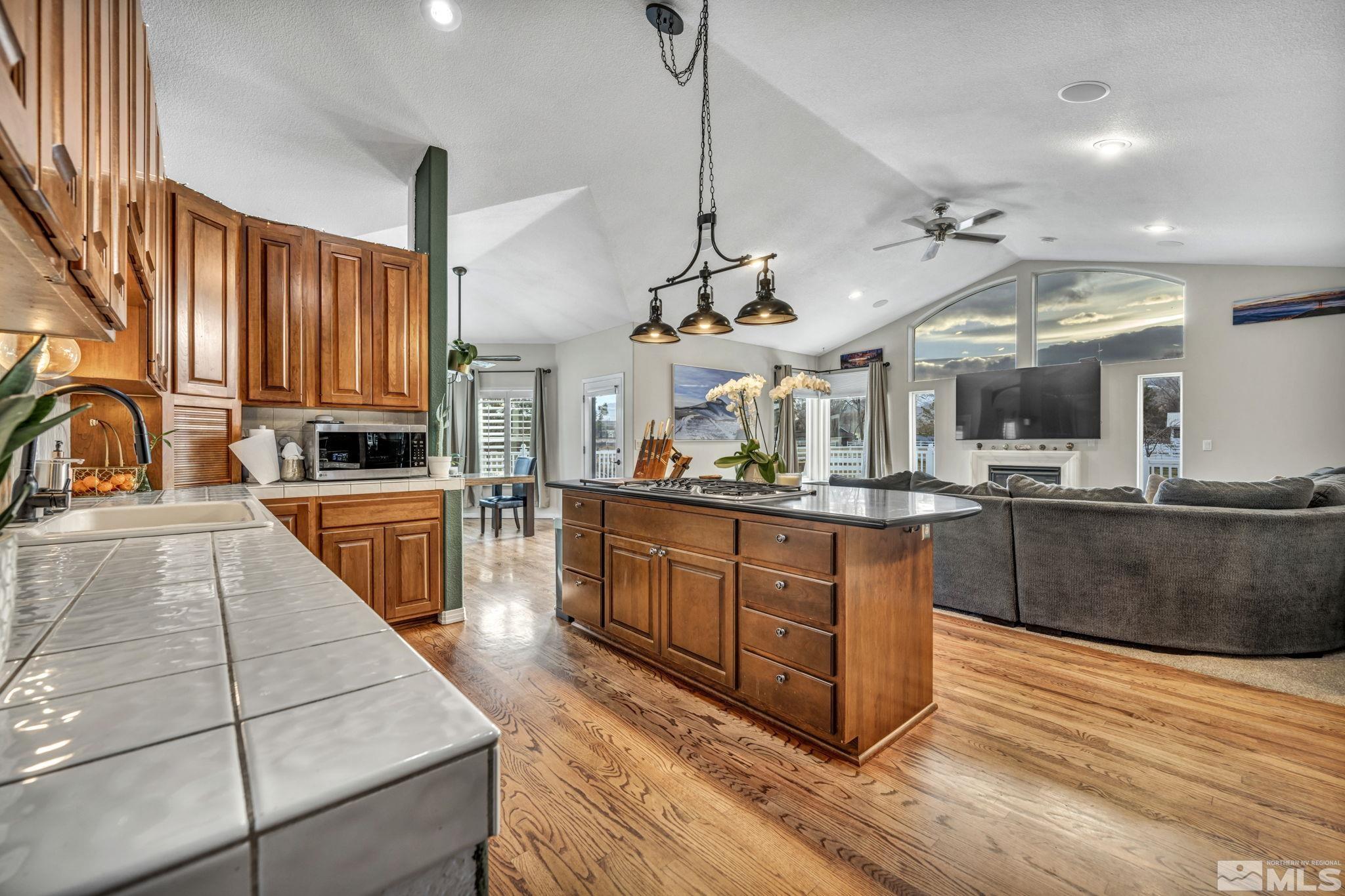 9811 Dixon Lane Reno, NV 89511 - Photo 10 of 40 a kitchen with stainless steel appliances granite countertop a sink a stove and a wooden floors