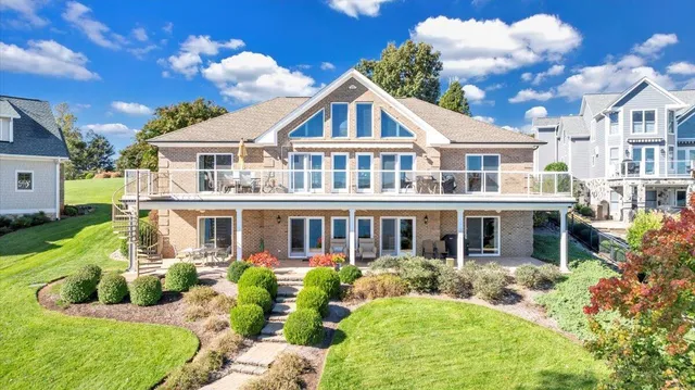 a front view of a house with a yard table and chairs