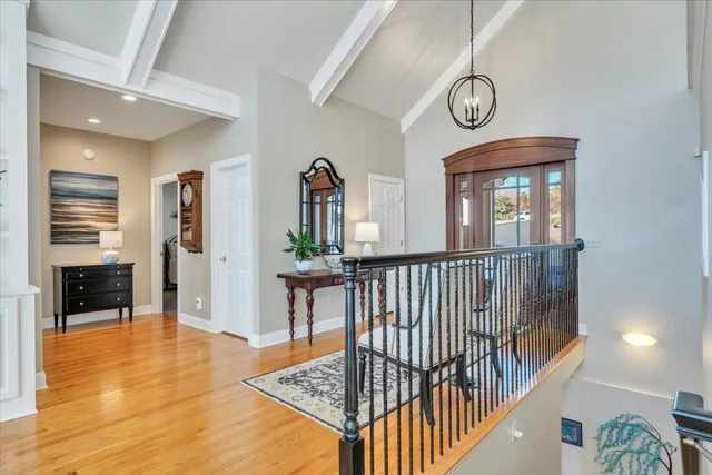 a spacious bathroom with a granite countertop sink a toilet and a mirror