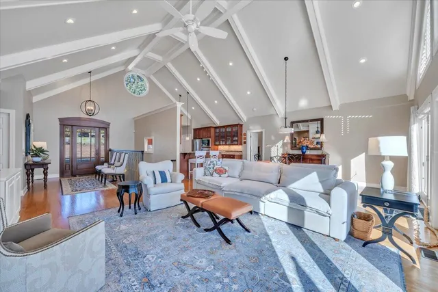 a dining room with furniture a fireplace and wooden floor