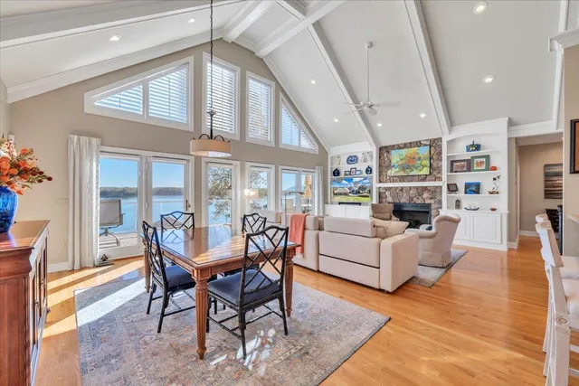 a living room with furniture a ceiling fan and a large window