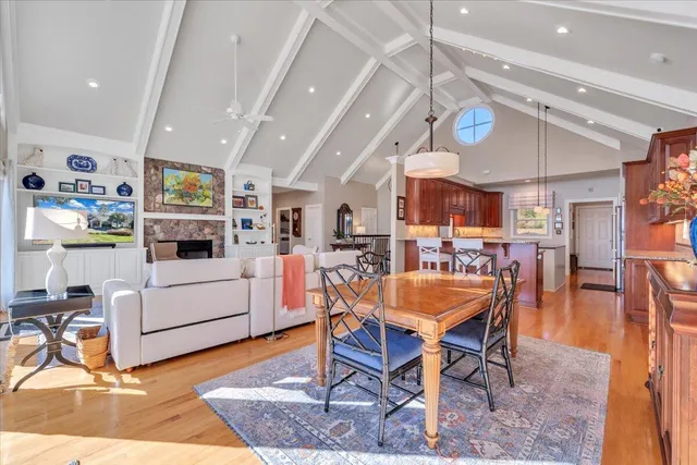 a living room with furniture a ceiling fan and a rug