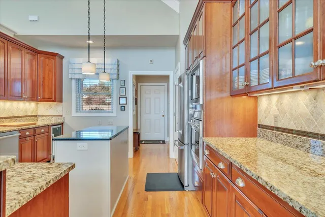 a front view of a house with a yard and potted plants