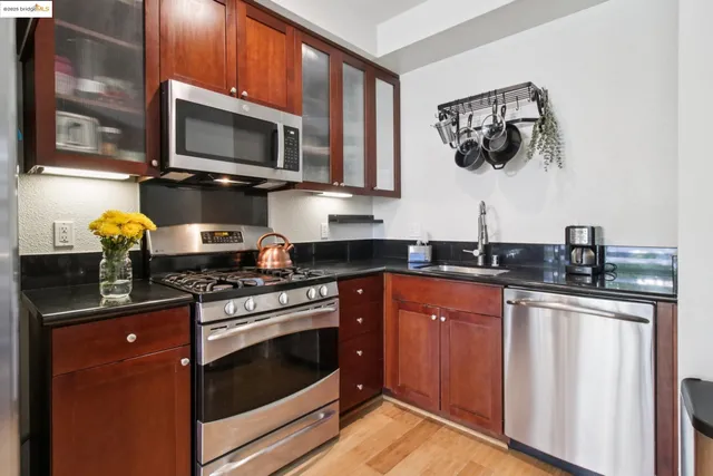 a kitchen with stainless steel appliances a stove microwave and cabinets