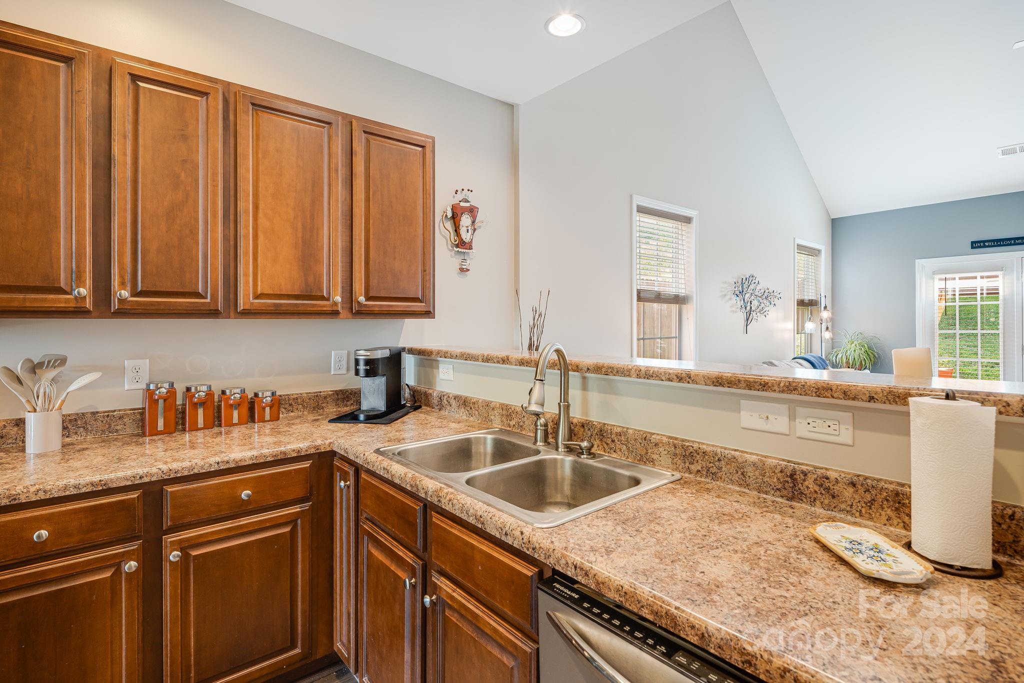 101 Ledbetter Road Arden, NC 28704 - Photo 11 of 34 a kitchen with granite countertop a sink a stove and cabinets