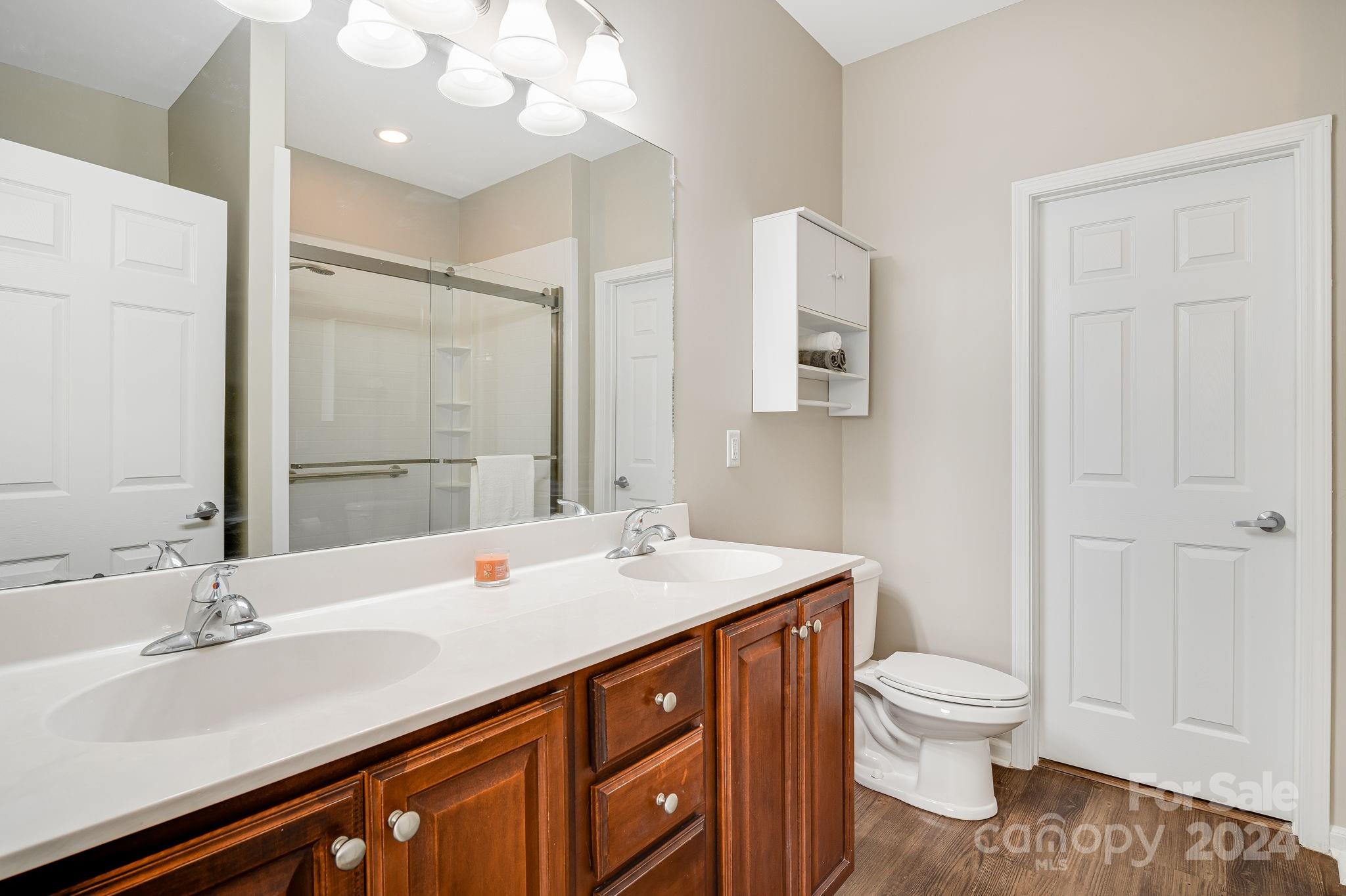 101 Ledbetter Road Arden, NC 28704 - Photo 14 of 34 a bathroom with a sink a toilet and shower