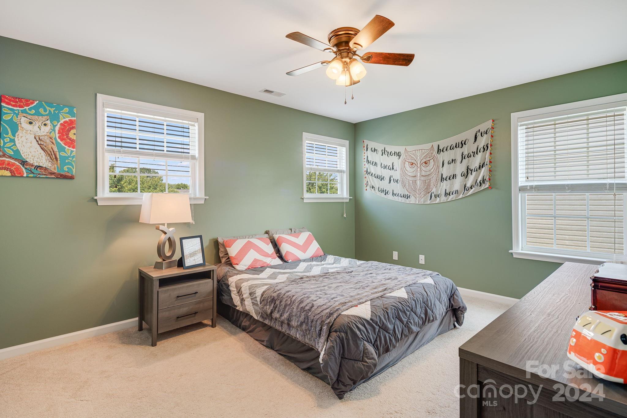 101 Ledbetter Road Arden, NC 28704 - Photo 17 of 34 a bedroom with a bed and a chandelier