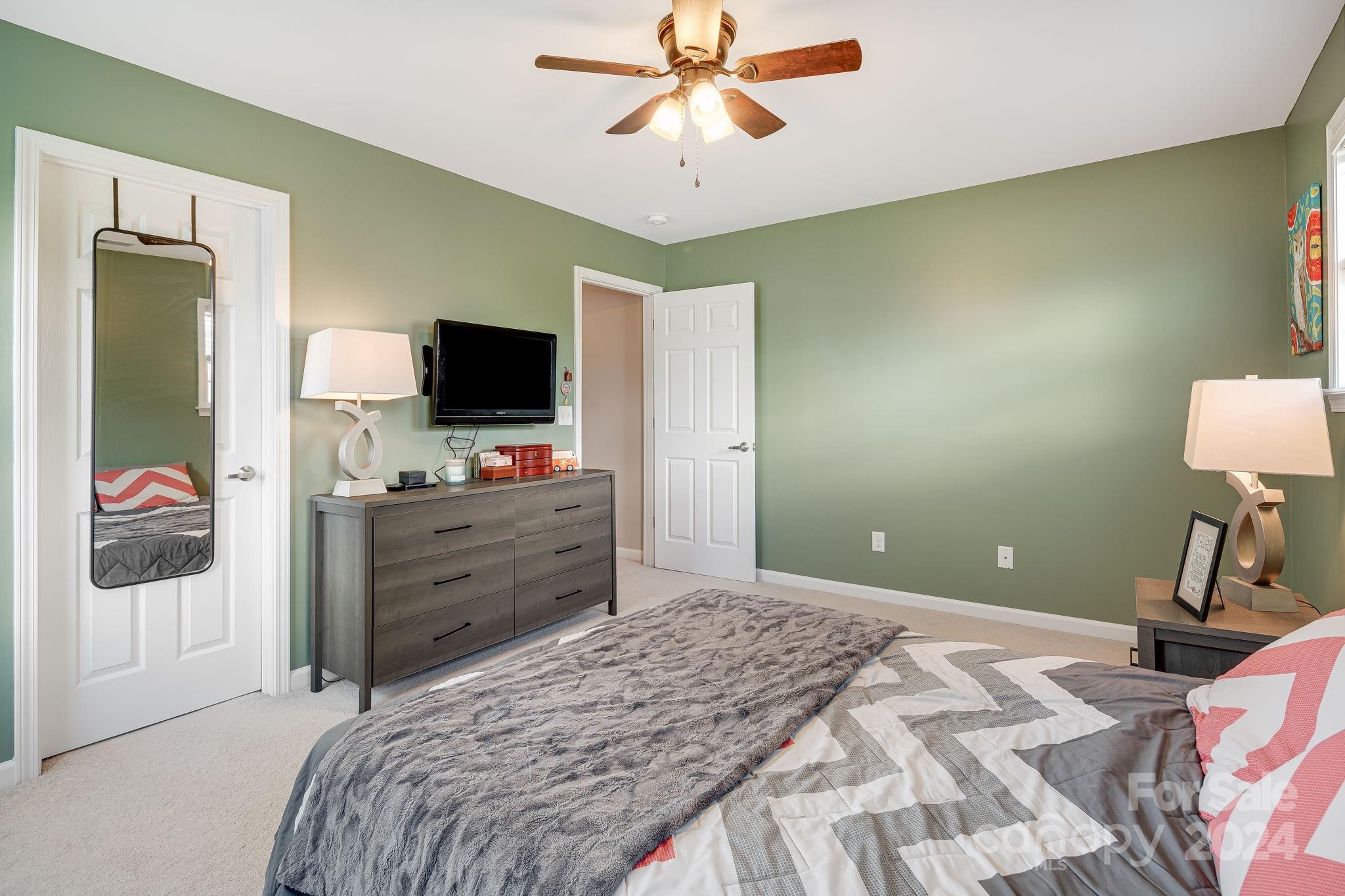 101 Ledbetter Road Arden, NC 28704 - Photo 18 of 34 a bedroom with a bed and a flat tv screen on dresser