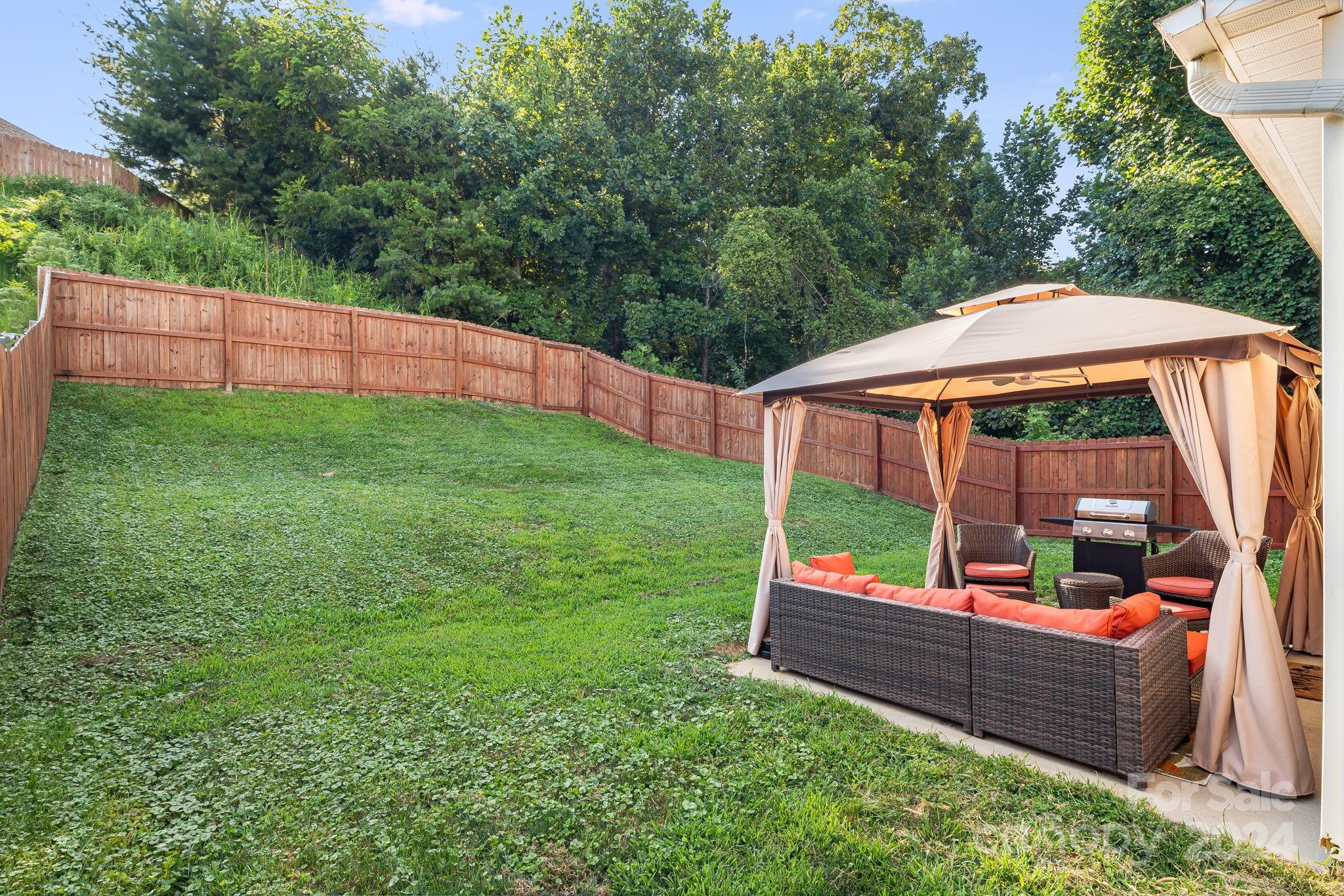 101 Ledbetter Road Arden, NC 28704 - Photo 24 of 34 an outdoor sitting area with lots of green trees in the background