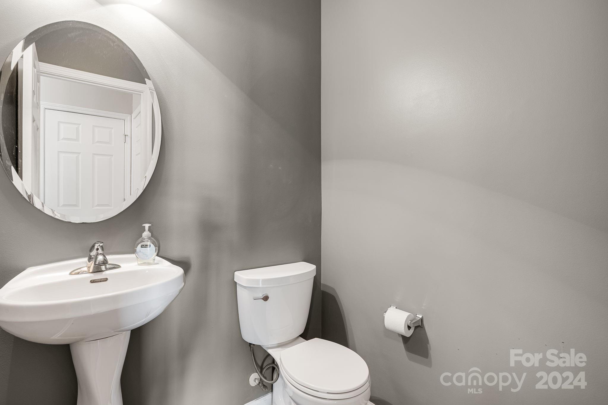 101 Ledbetter Road Arden, NC 28704 - Photo 26 of 34 a bathroom with a toilet sink and mirror