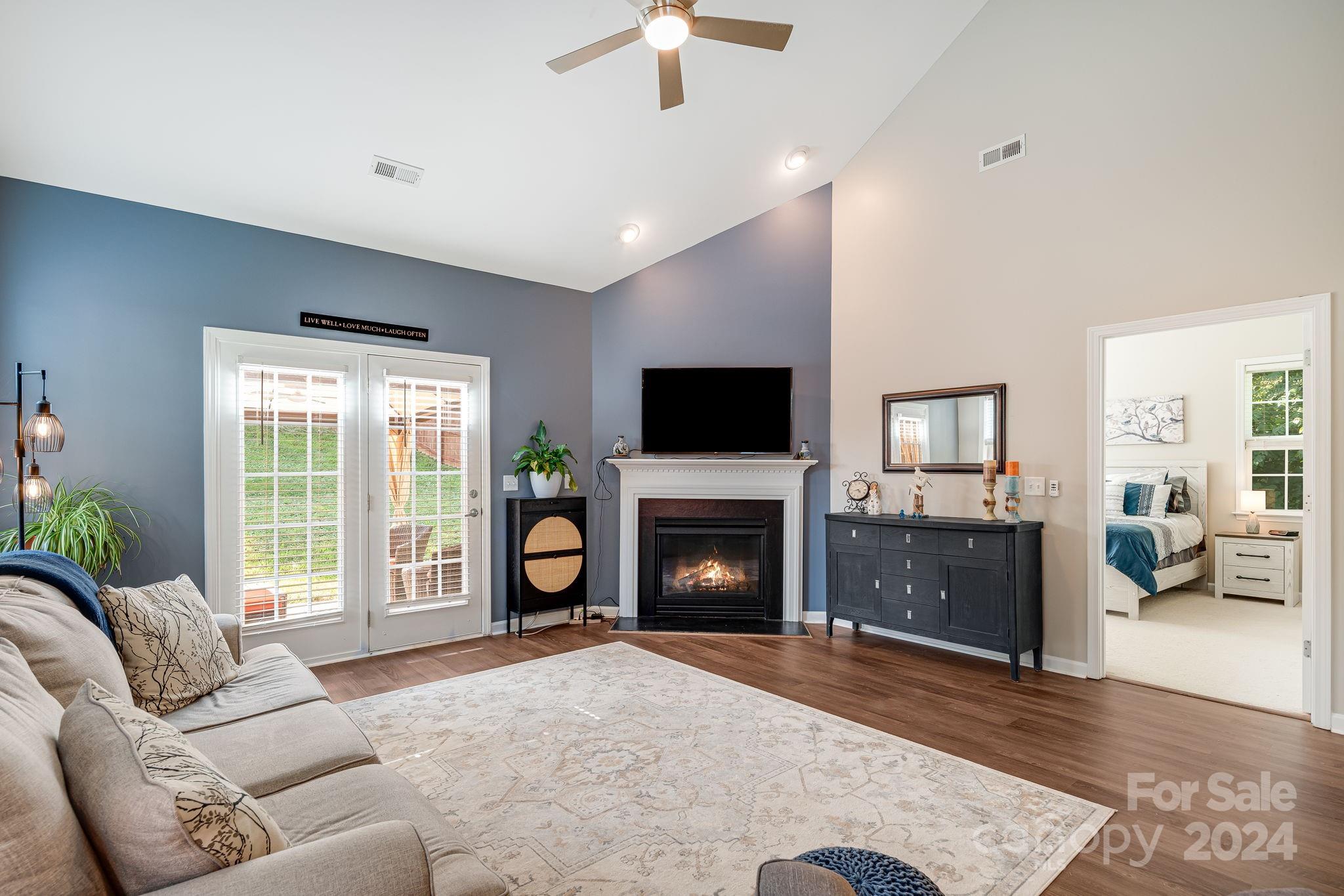 101 Ledbetter Road Arden, NC 28704 - Photo 4 of 34 a living room with furniture a fireplace and a flat screen tv