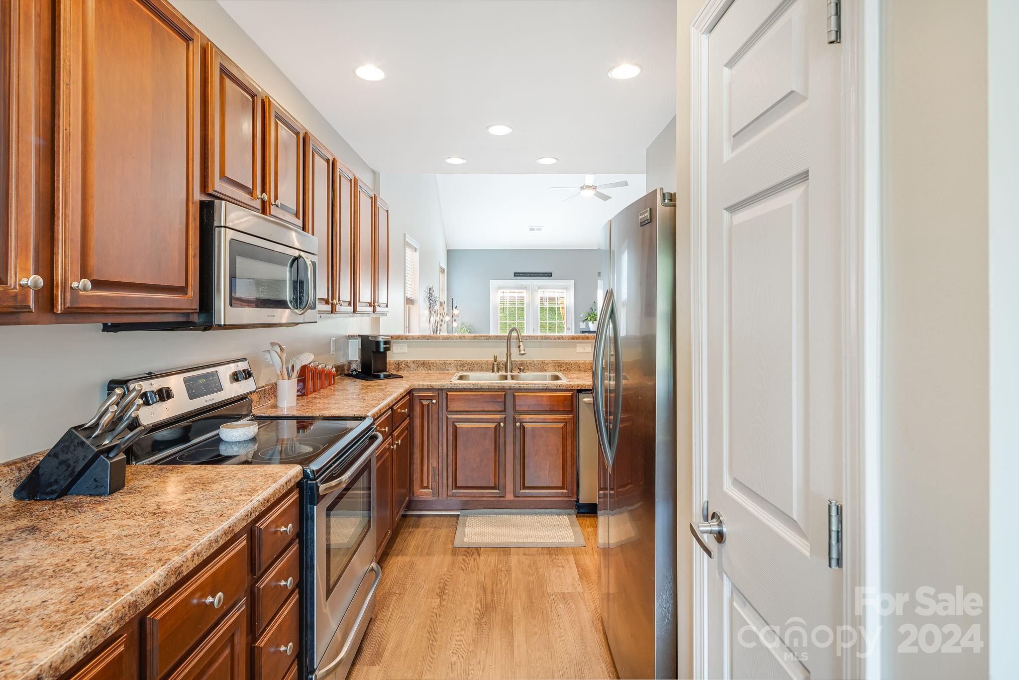 101 Ledbetter Road Arden, NC 28704 - Photo 7 of 34 a kitchen with stainless steel appliances granite countertop a stove a sink and a refrigerator