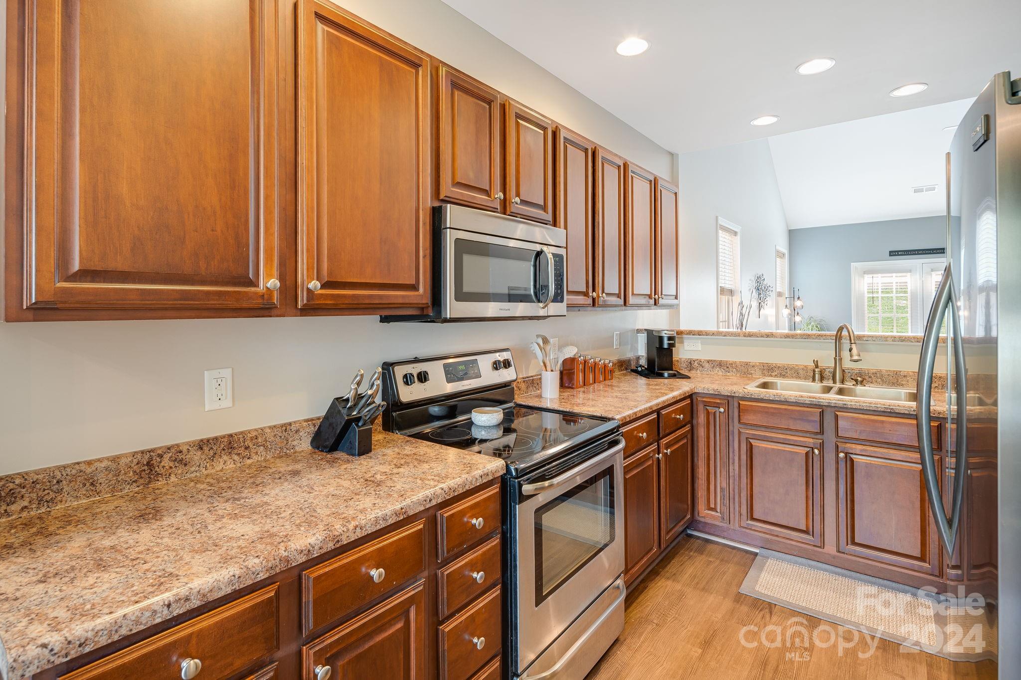 101 Ledbetter Road Arden, NC 28704 - Photo 10 of 34 a kitchen with stainless steel appliances granite countertop a stove a sink and a microwave