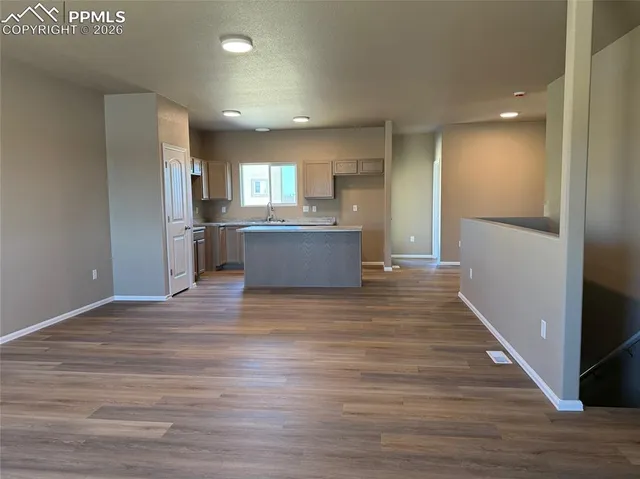 a view of a kitchen with a sink and a refrigerator