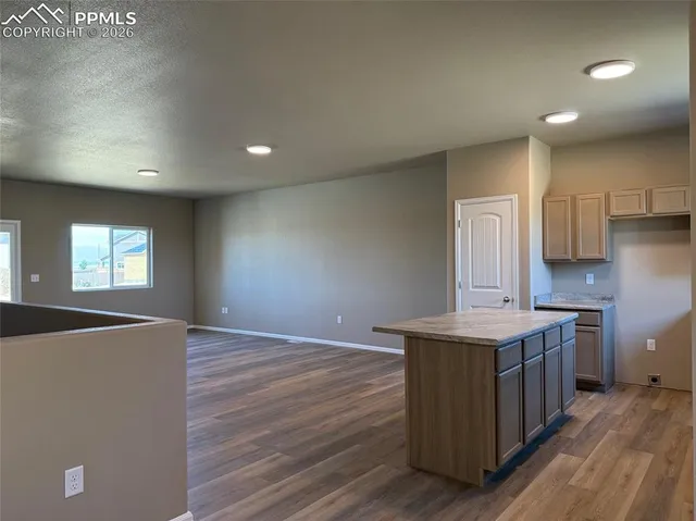 an empty room with windows and closet