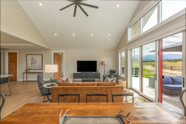 a living room with furniture pool and a large window
