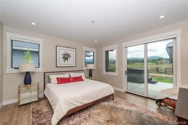 a bedroom with a large bed and a window