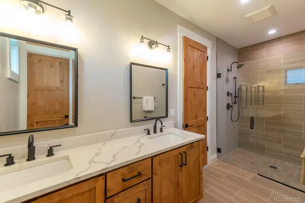 a bathroom with a shower sink and mirror