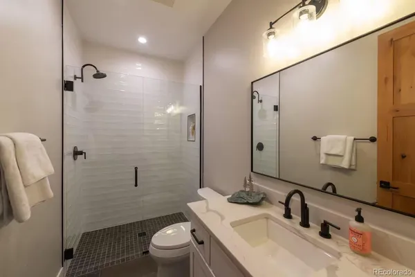 a bathroom with a sink toilet and shower