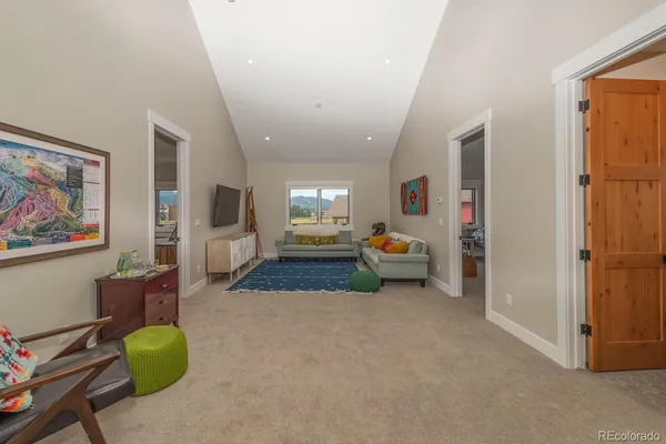 a living room with furniture and a chandelier