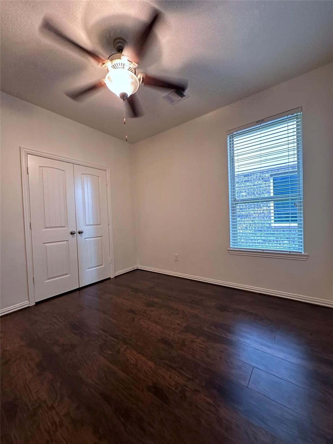 175 West New Harmony Trail Spring, TX 77389 - Photo 13 of 16 an empty room with wooden floor chandelier fan and windows