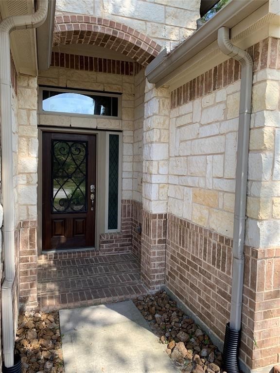175 West New Harmony Trail Spring, TX 77389 - Photo 2 of 16 a view of a porch with a bench