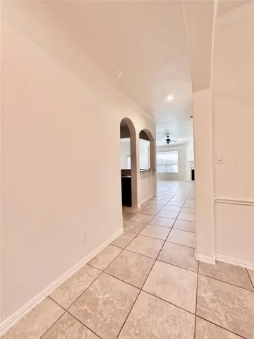 a view of a livingroom with wooden floor and a refrigerator