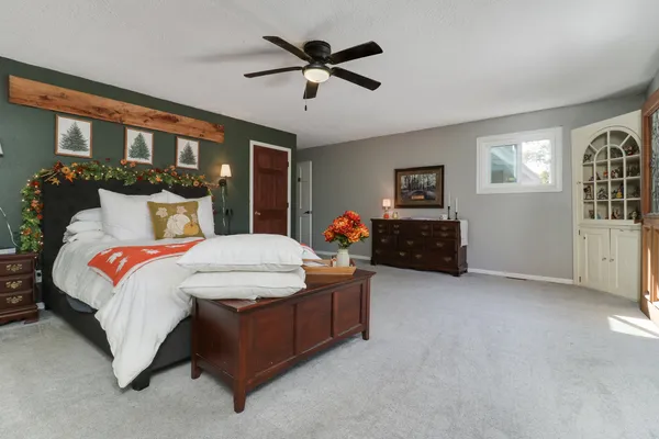 a bedroom with a bed and a chandelier