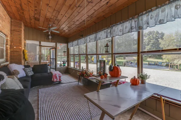 a living room with furniture a rug and a large window