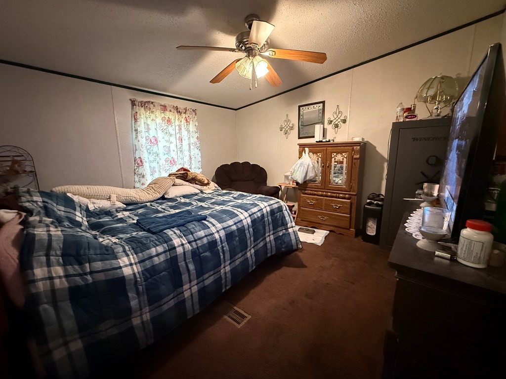 920 Pioneer Road Grimsley, TN 38565 - Photo 8 of 15 a bedroom with a bed and a chandelier