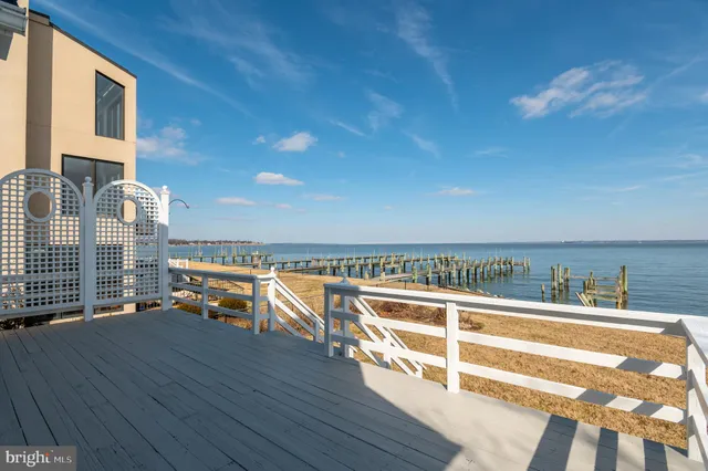 a view of a balcony with dining table and chairs with wooden floor