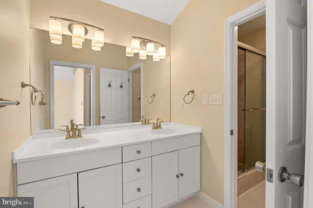 a bathroom with a double vanity sink mirror and
