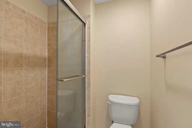 a bathroom with a toilet and a shower
