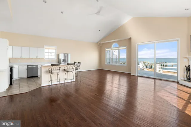 a living room with furniture and a kitchen view