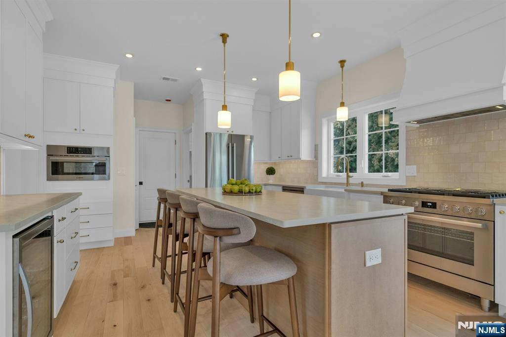 2127 Locust Road Sea Girt, NJ 08750 - Photo 18 of 48 a kitchen with stainless steel appliances granite countertop a sink a stove and a refrigerator