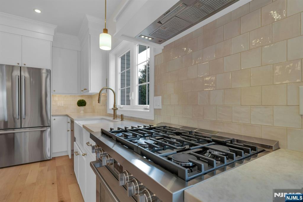 2127 Locust Road Sea Girt, NJ 08750 - Photo 19 of 48 a stove top oven sitting inside of a kitchen