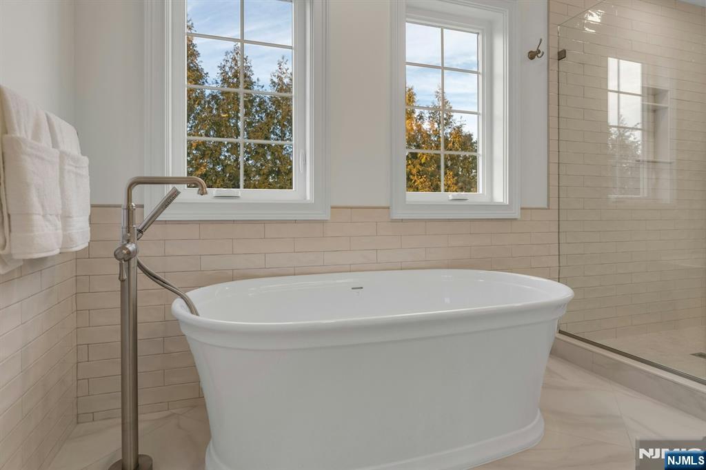 2127 Locust Road Sea Girt, NJ 08750 - Photo 34 of 48 a white bath tub sitting in a bathroom next to a window