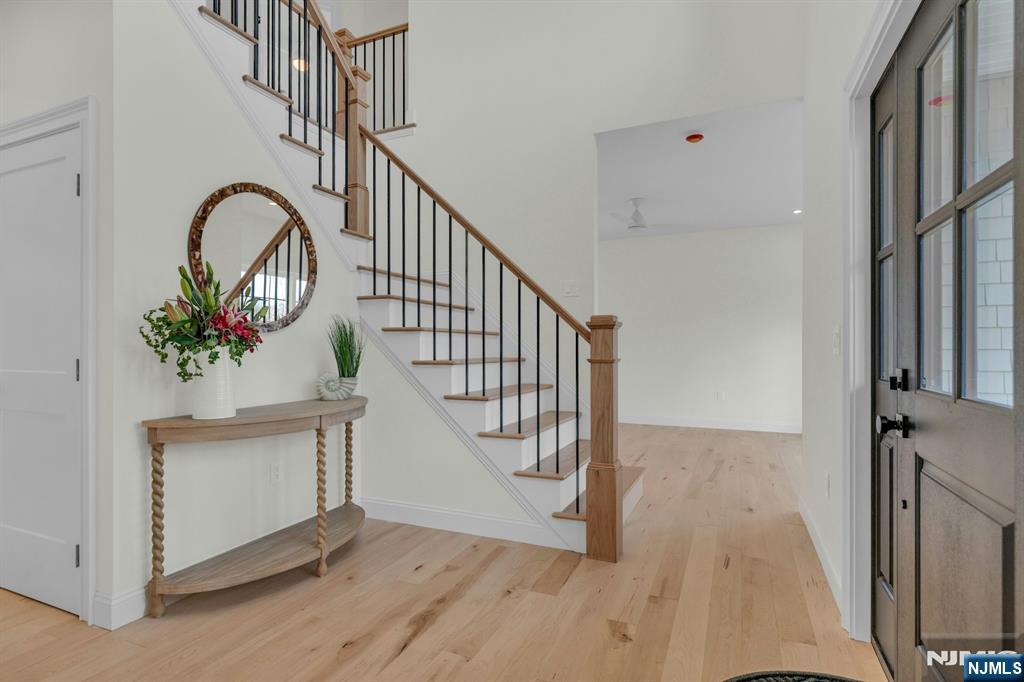 2127 Locust Road Sea Girt, NJ 08750 - Photo 5 of 48 a view of staircase with wooden floor and a potted plant