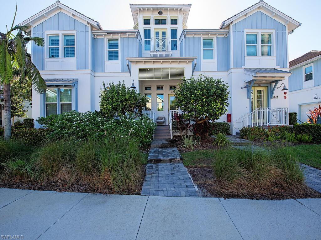 a front view of a residential apartment building with a yard