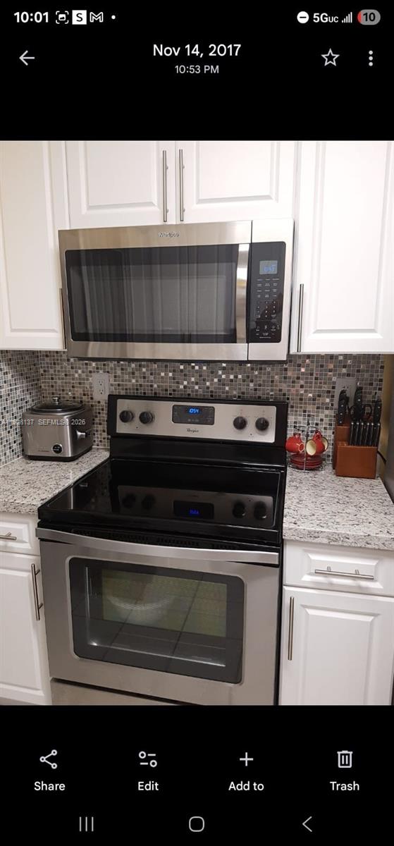 5850 West 18th Lane, Unit 103 Hialeah, FL 33012 - Photo 4 of 4 a kitchen with a stove and a microwave