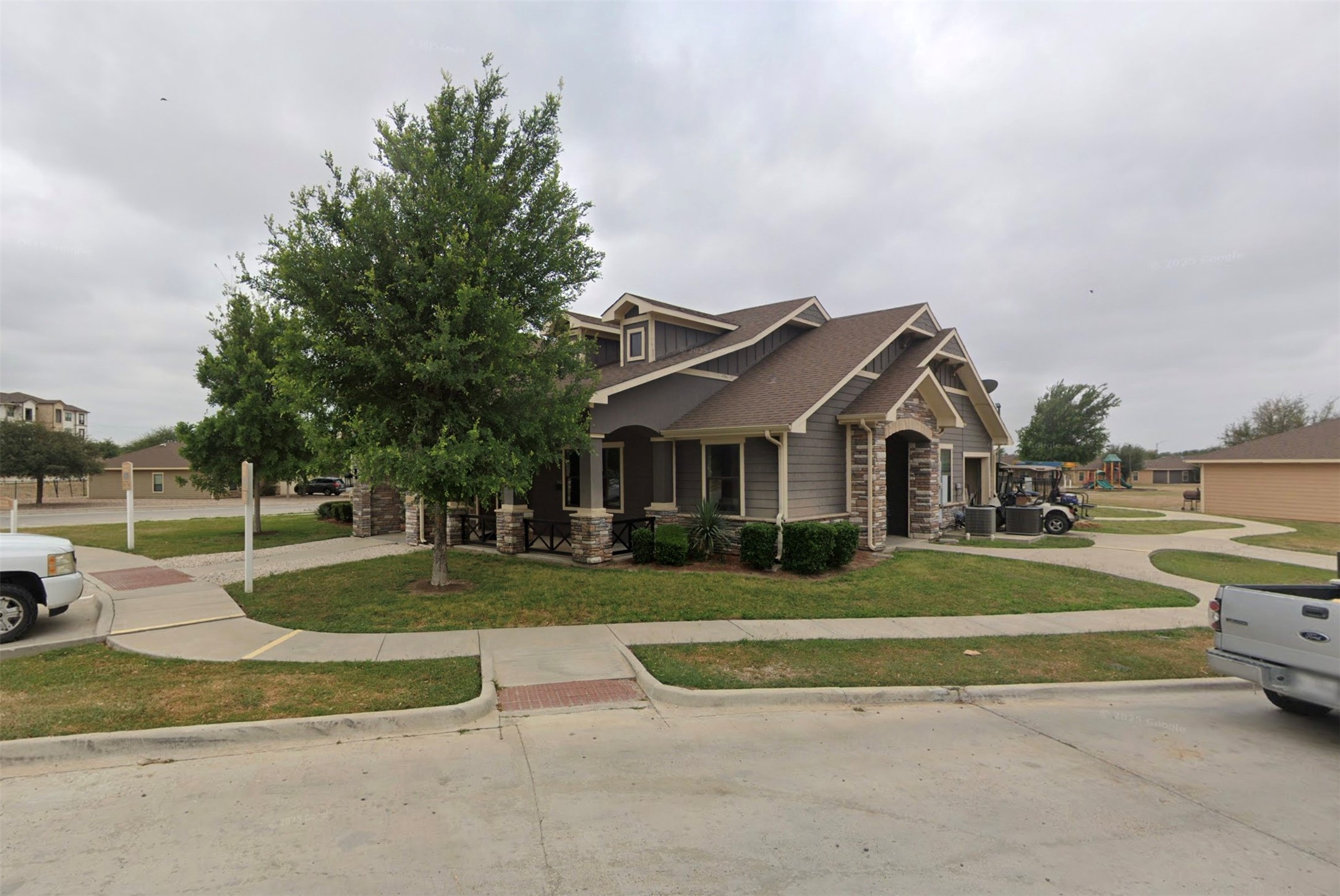 2640 Chapote Loop Eagle Pass, TX 78852 - Photo 2 of 6 a view of a white house with a big yard and potted plants and large trees