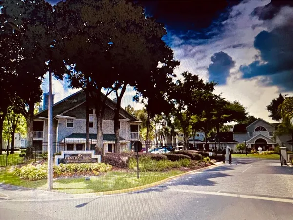 a view of a building with cars parked on the road