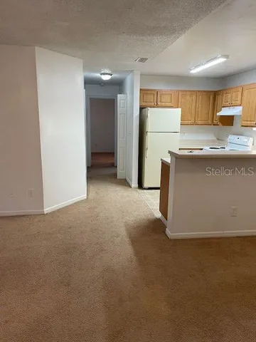 a view of kitchen and refrigerator in a kitchen