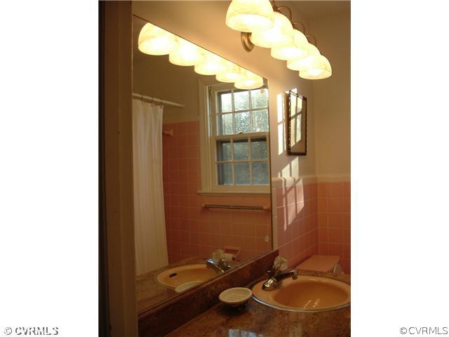 301 Wilkinson Road Richmond, VA 23227 - Photo 14 of 16 a bathroom with a sink and a mirror