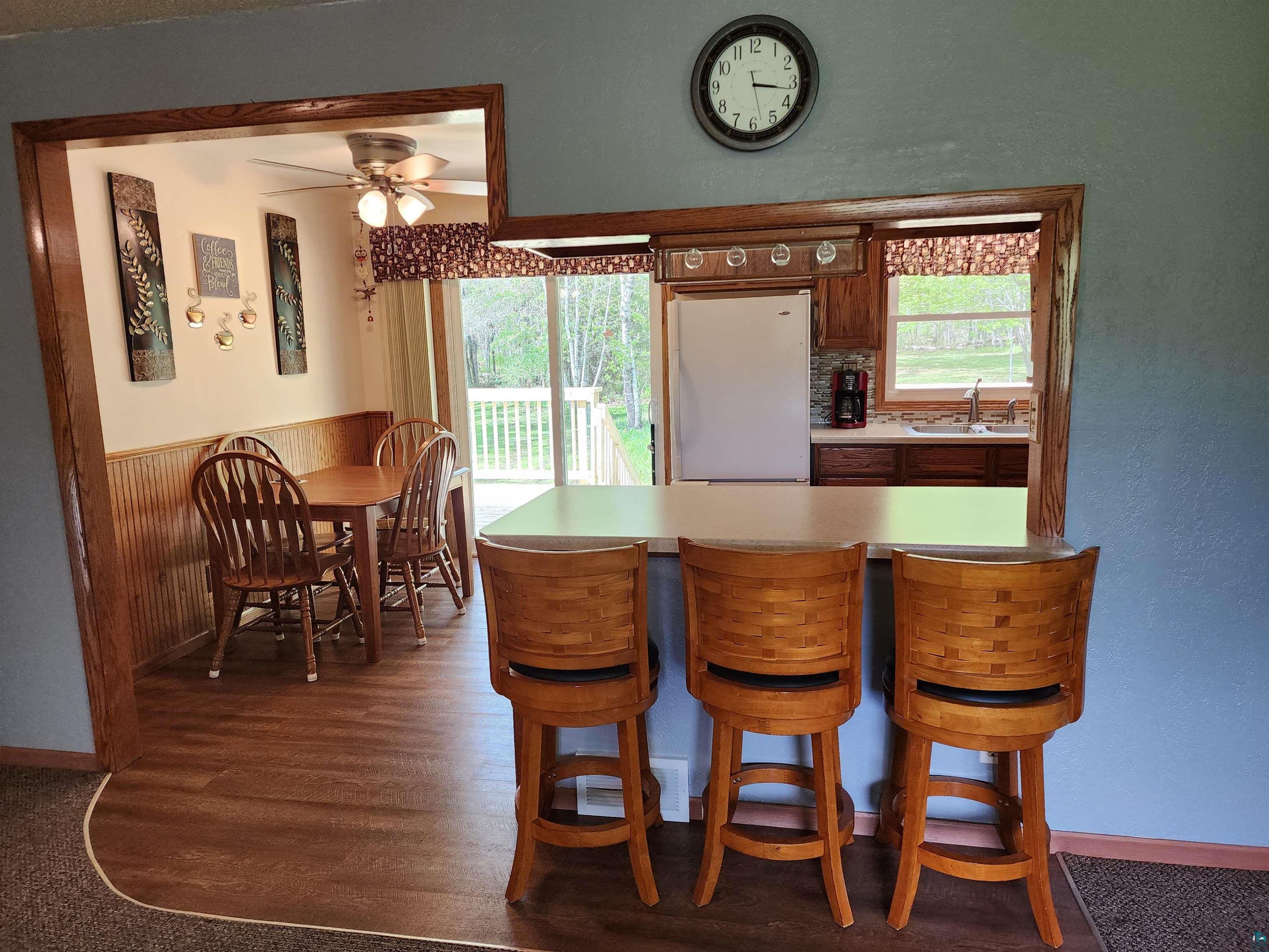 4179 Willard Road Rice Lake, MN 55803 - Photo 8 of 39 Dining space with sink, plenty of natural light, ceiling fan, and dark hardwood / wood-style floors